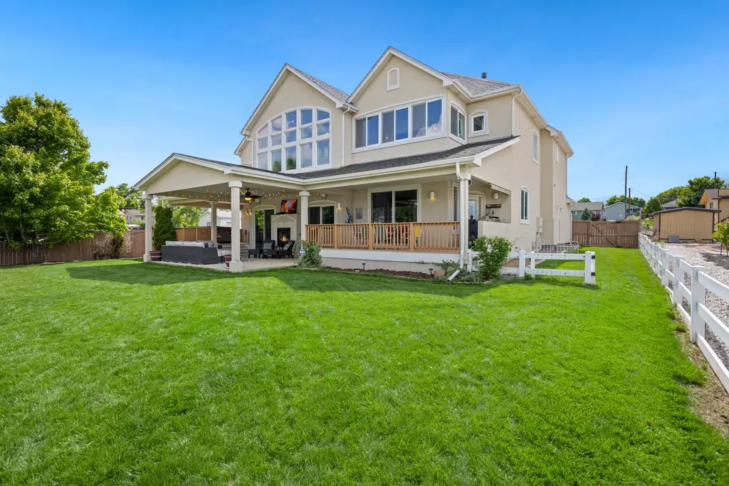 Two-story home with a wide green lawn and porch